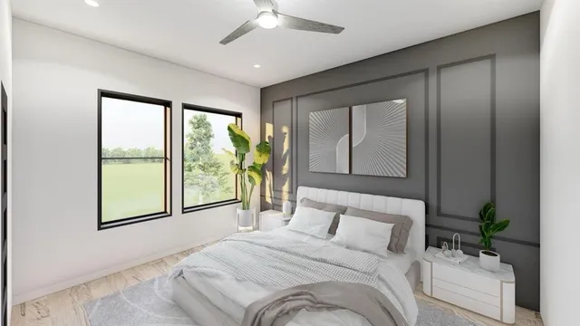 a bedroom with a large bed and a large window with the outer view