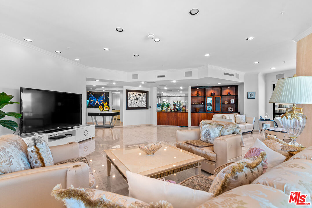 10490 Wilshire Boulevard, Unit 1206 Los Angeles, CA 90024 - Photo 12 of 44 a living room with furniture and a flat screen tv