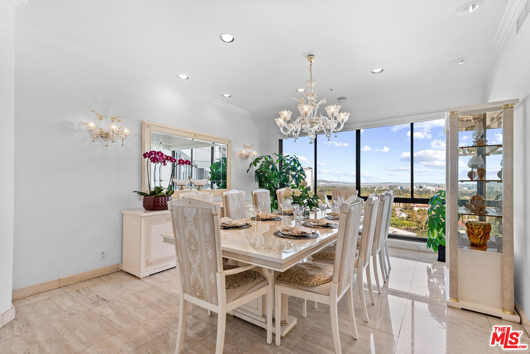 10490 Wilshire Boulevard, Unit 1206 Los Angeles, CA 90024 - Photo 13 of 44 a dining room with furniture a chandelier and a rug