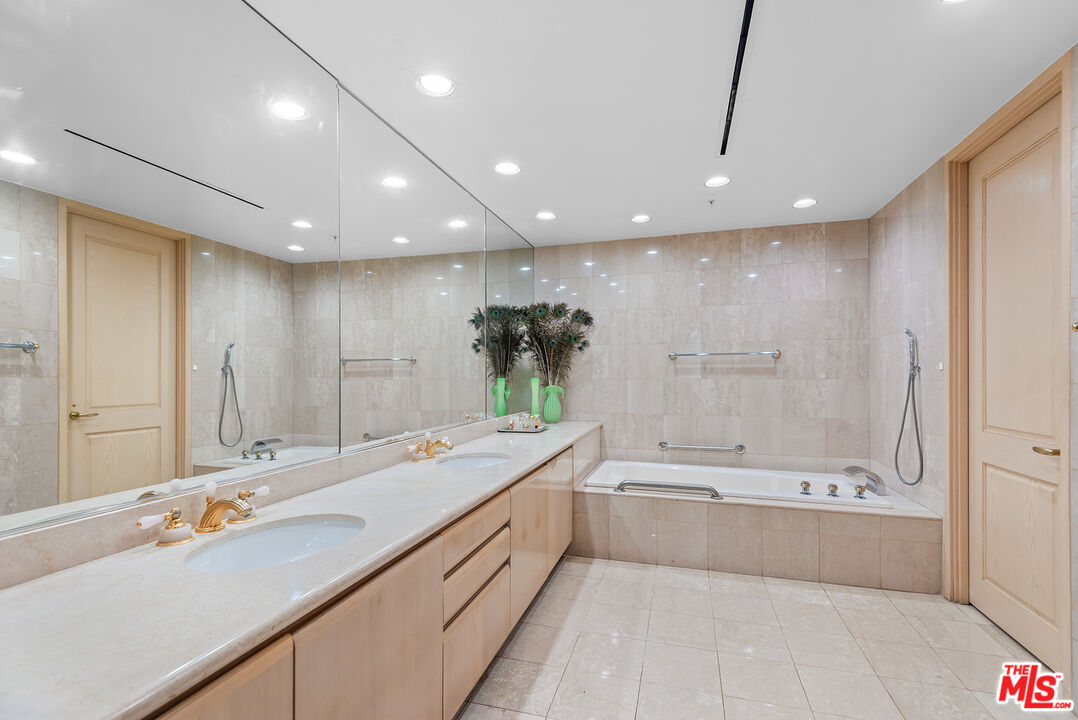 10490 Wilshire Boulevard, Unit 1206 Los Angeles, CA 90024 - Photo 26 of 44 a spacious bathroom with a large tub shower and sink