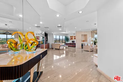 a lobby with furniture and a potted plant