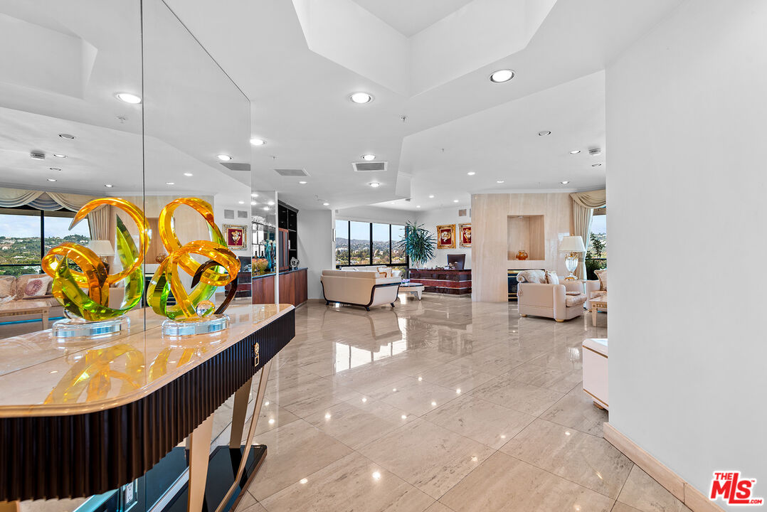 10490 Wilshire Boulevard, Unit 1206 Los Angeles, CA 90024 - Photo 3 of 44 a lobby with furniture and a potted plant