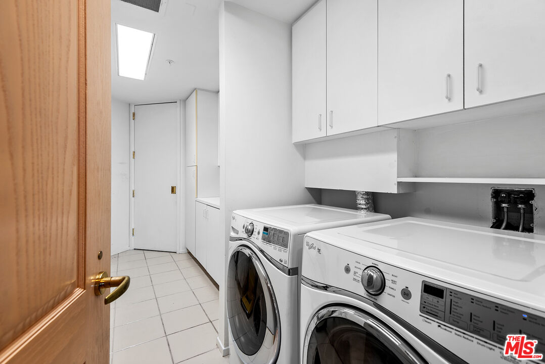 10490 Wilshire Boulevard, Unit 1206 Los Angeles, CA 90024 - Photo 31 of 44 a view of storage and utility room with washer and dryer