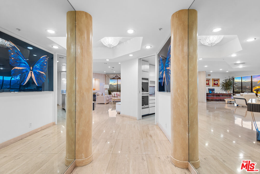10490 Wilshire Boulevard, Unit 1206 Los Angeles, CA 90024 - Photo 5 of 44 a view of a hallway with dining area and chandelier