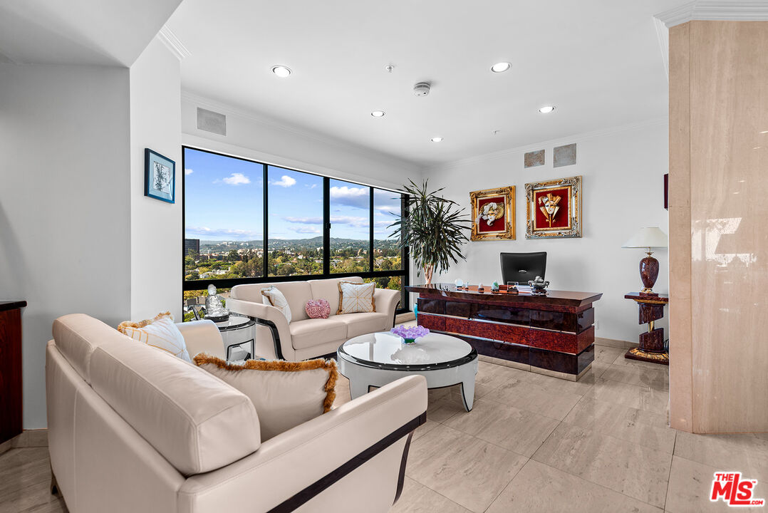 10490 Wilshire Boulevard, Unit 1206 Los Angeles, CA 90024 - Photo 6 of 44 a living room with furniture and a large window