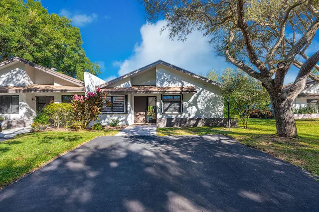 a view of a house with pool and a yard