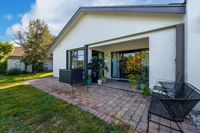 a view of a house with backyard porch and sitting area