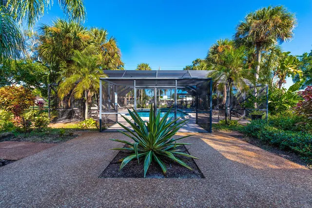 a view of a patio with table and chairs under an umbrella