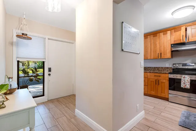a kitchen with stainless steel appliances granite countertop a refrigerator and a sink