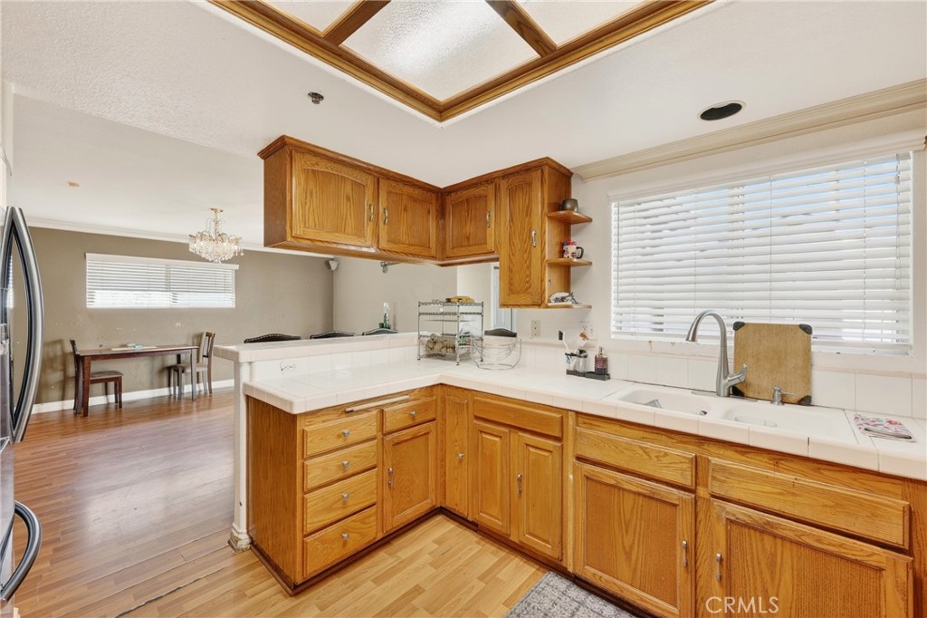 10939 Little Lake Road Downey, CA 90241 - Photo 11 of 55 a kitchen with a sink cabinets and wooden floor