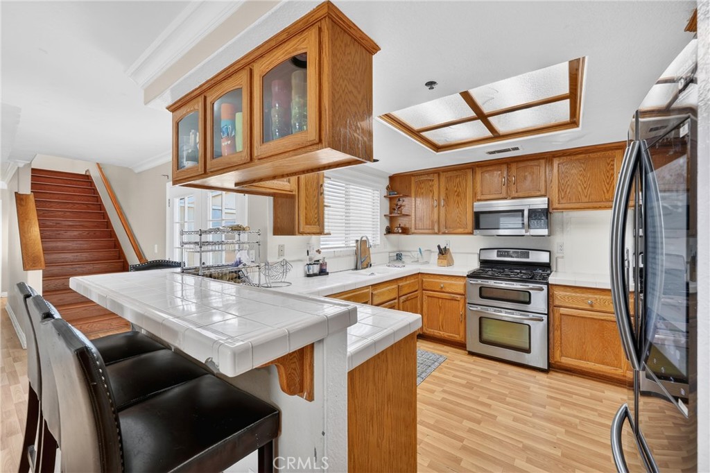 10939 Little Lake Road Downey, CA 90241 - Photo 14 of 55 a kitchen with stainless steel appliances granite countertop a stove refrigerator and a sink