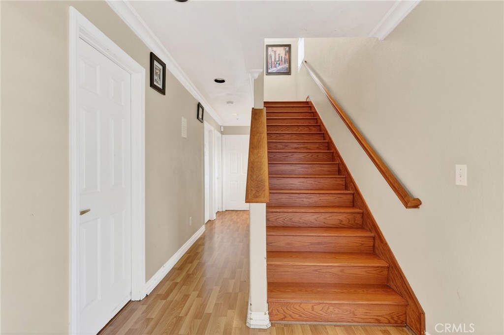 10939 Little Lake Road Downey, CA 90241 - Photo 17 of 55 a view of staircase with wooden floor and white walls