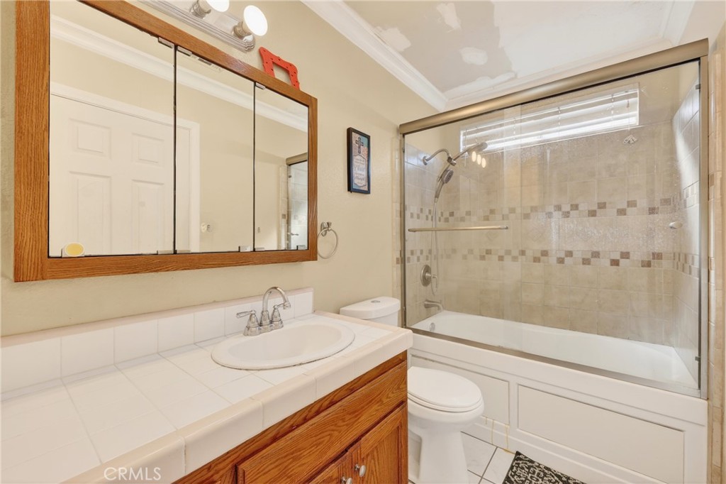 10939 Little Lake Road Downey, CA 90241 - Photo 18 of 55 a bathroom with a granite countertop sink a toilet and shower