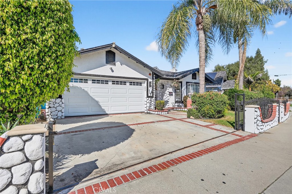 10939 Little Lake Road Downey, CA 90241 - Photo 2 of 55 a front view of a house with a yard and garage