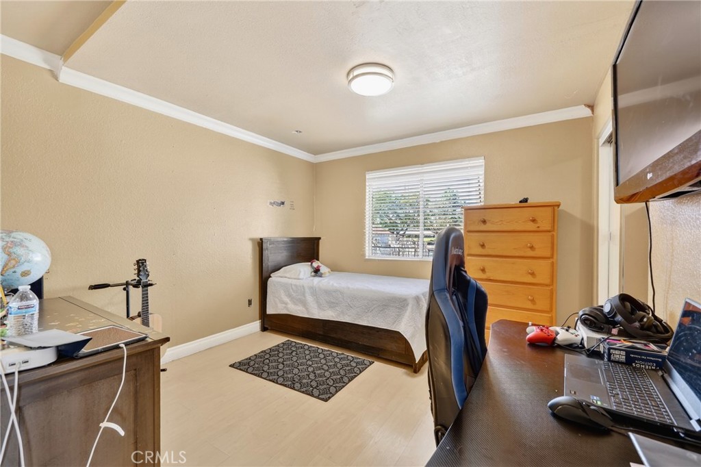 10939 Little Lake Road Downey, CA 90241 - Photo 21 of 55 a bedroom with a bed and wooden floor