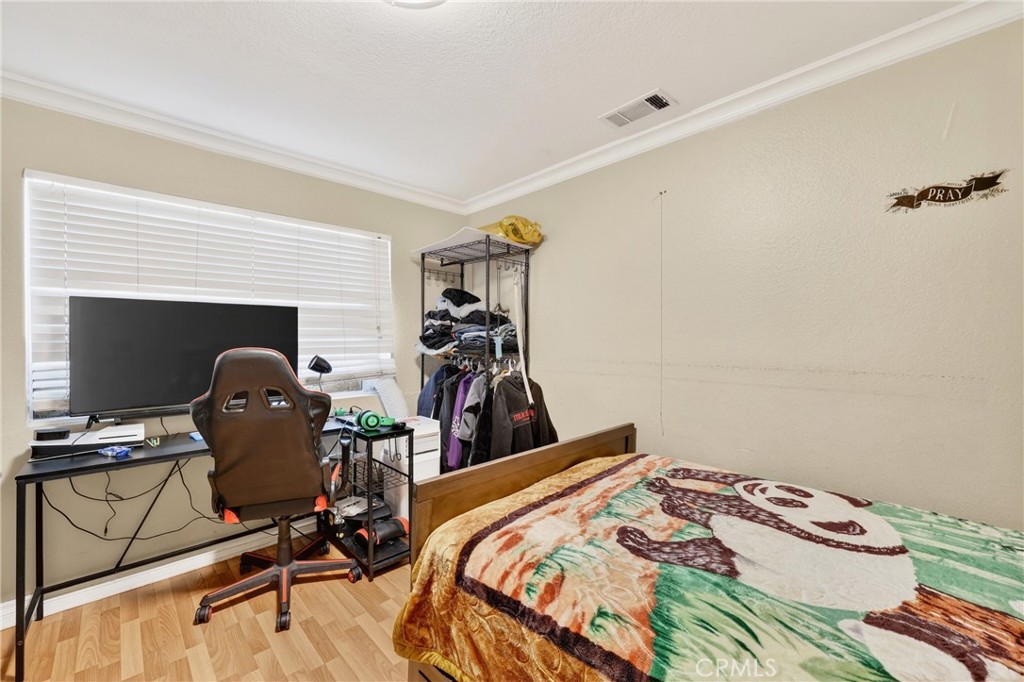 10939 Little Lake Road Downey, CA 90241 - Photo 22 of 55 a bedroom with a bed and a gym machine