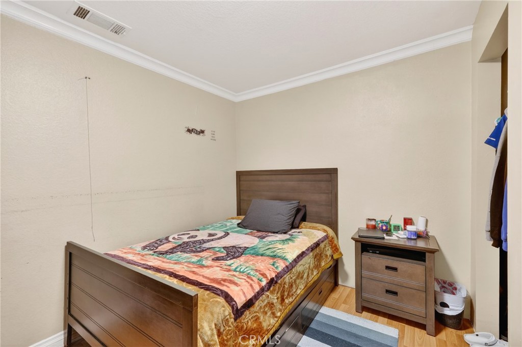 10939 Little Lake Road Downey, CA 90241 - Photo 23 of 55 a bedroom with a bed and a dresser in it