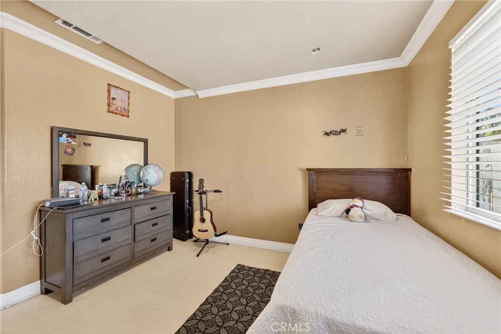 10939 Little Lake Road Downey, CA 90241 - Photo 24 of 55 a bed room with a bed and a dresser