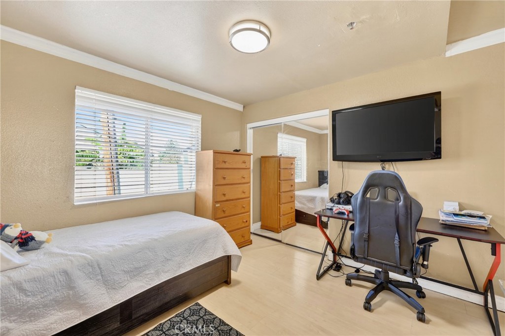 10939 Little Lake Road Downey, CA 90241 - Photo 25 of 55 a bedroom with furniture and a flat screen tv