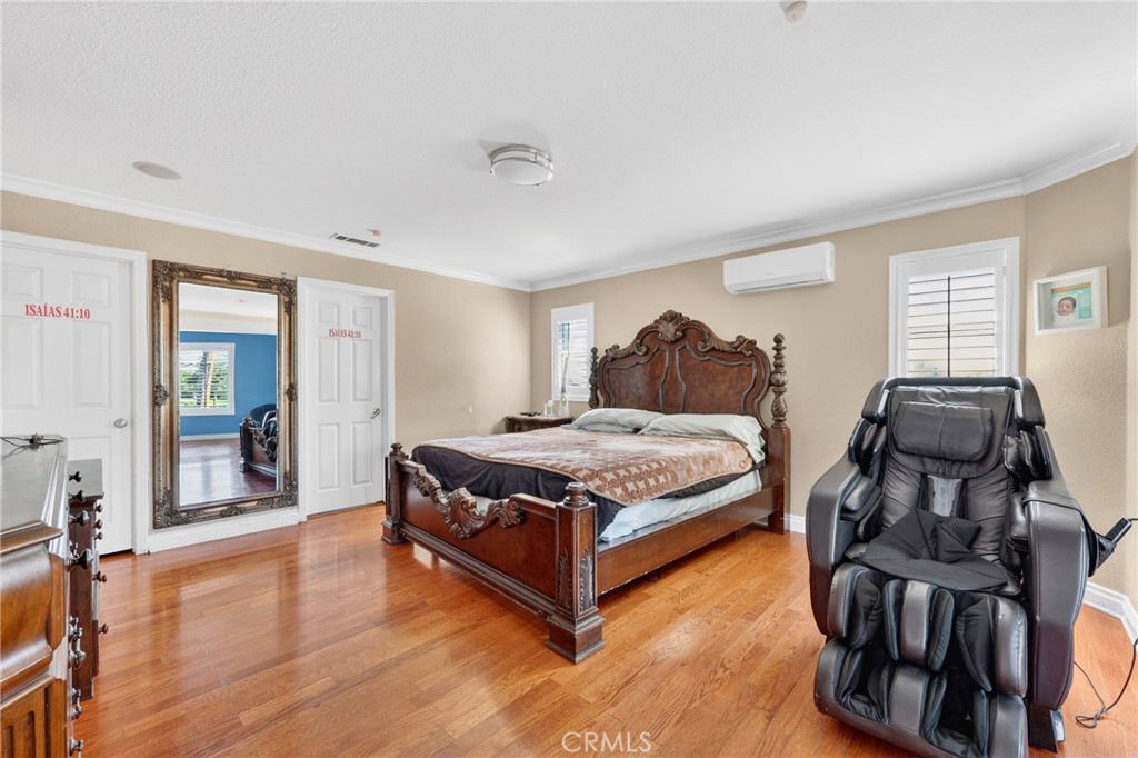 10939 Little Lake Road Downey, CA 90241 - Photo 26 of 55 a bedroom with a bed and wooden floor