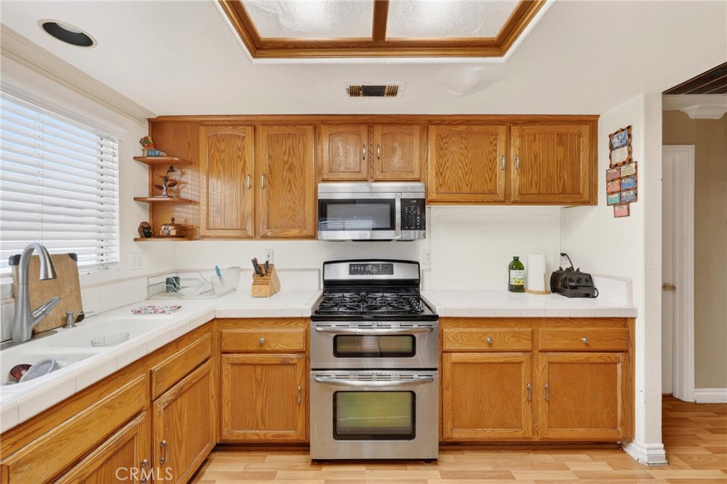 10939 Little Lake Road Downey, CA 90241 - Photo 9 of 55 a kitchen with a stove and a microwave