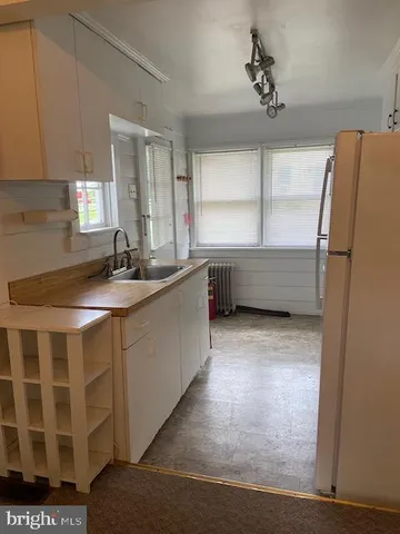 a kitchen with a sink and a refrigerator
