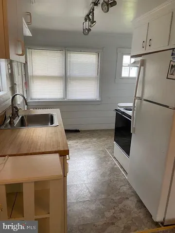 a kitchen with a refrigerator and a sink