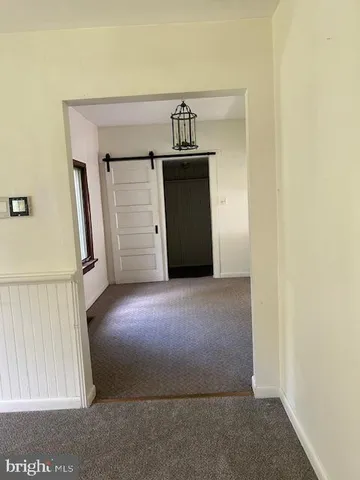 an empty room with a ceiling fan and sliding door