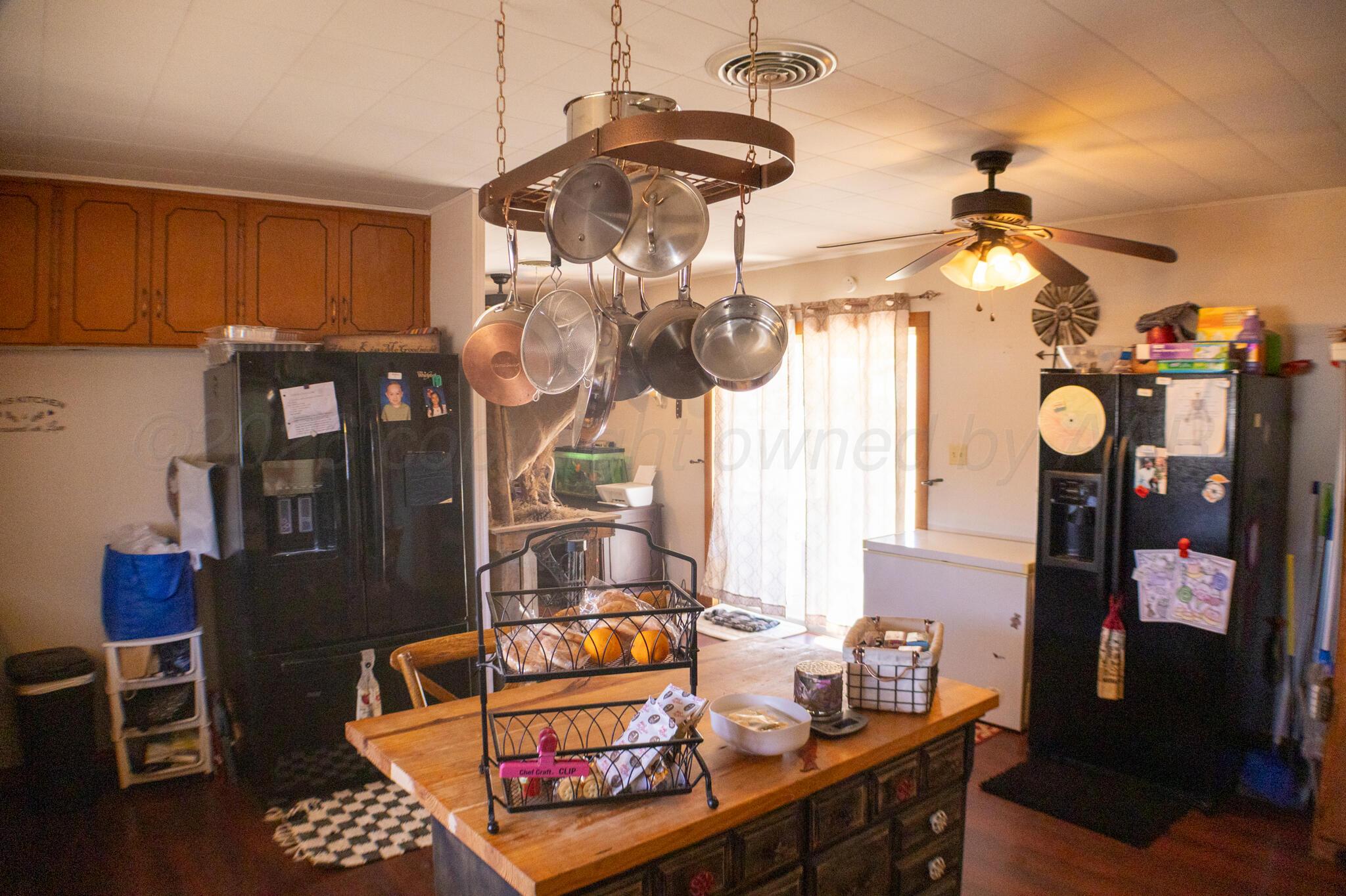 801 North Main Street McLean, TX 79057 - Photo 11 of 24 a room with lots of white furniture and chandelier
