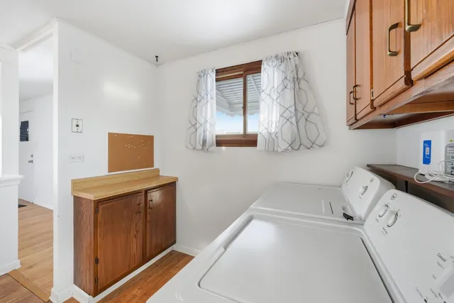 a kitchen with a sink cabinets stainless steel appliances and a window