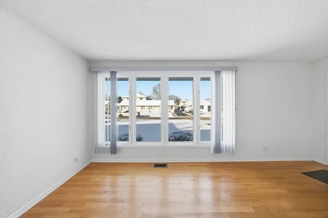a view of a kitchen with wooden floor and a sink