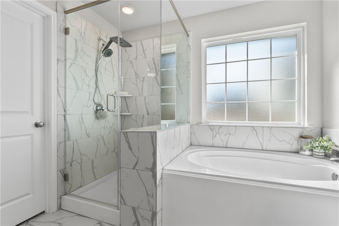 1925 Viva Road Bryan, TX 77807 - Photo 16 of 25 Full bathroom featuring marble finish flooring, a bath, and a marble finish shower