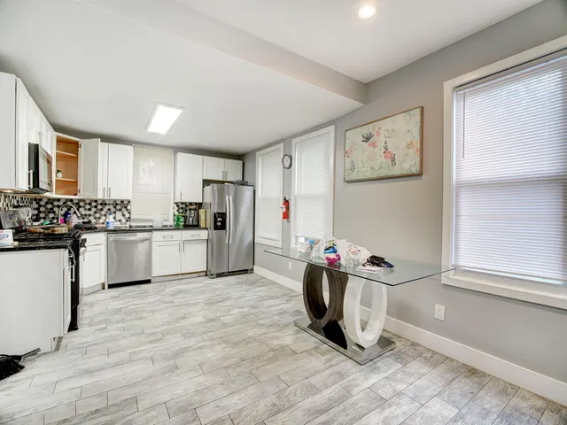 a kitchen with granite countertop a sink cabinets and window