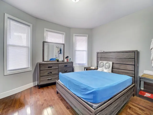 a bedroom with a bed and a dresser