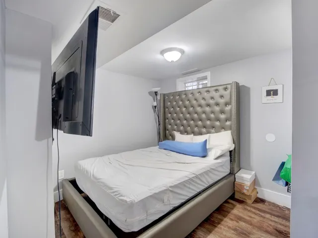 a bedroom with a bed and a wall painting