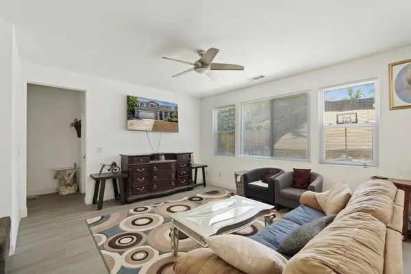 a living room with furniture a wooden floor and a window