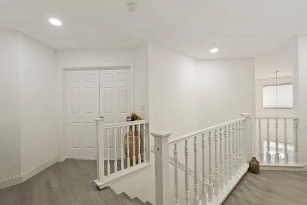 a bedroom with a bed a table and a window