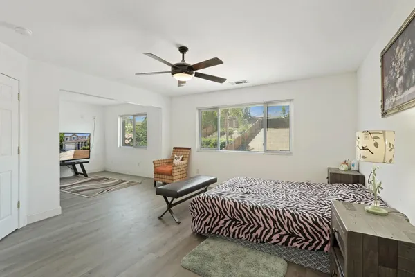 a view of a livingroom with lounge chair and a window