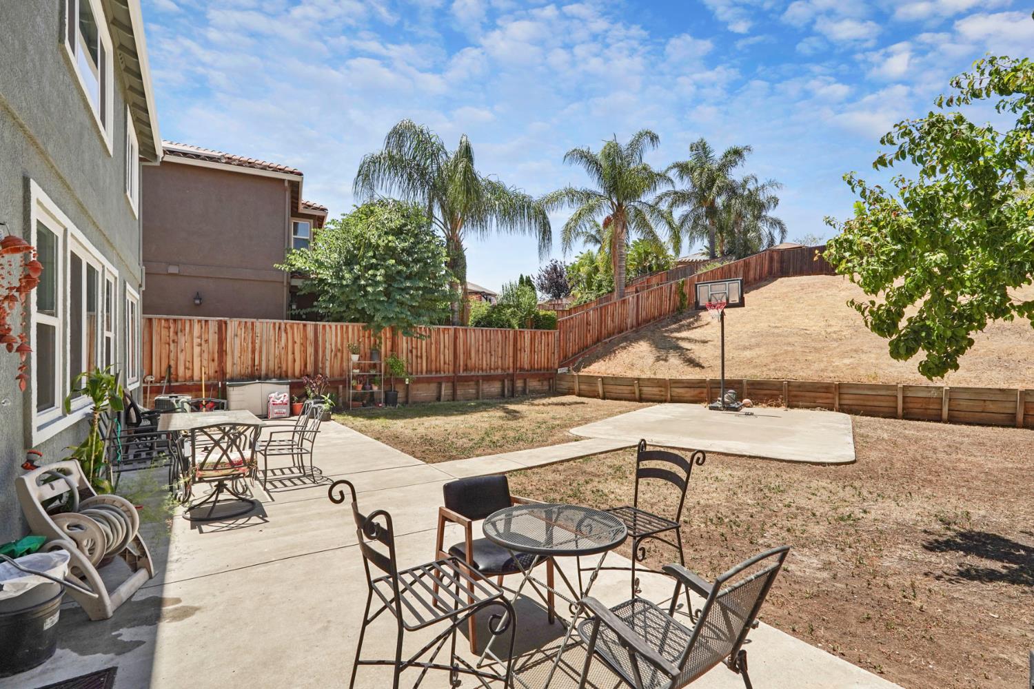 5447 Benttree Way Antioch, CA 94531 - Photo 49 of 55 a view of a patio with table and chairs potted plants with wooden floor