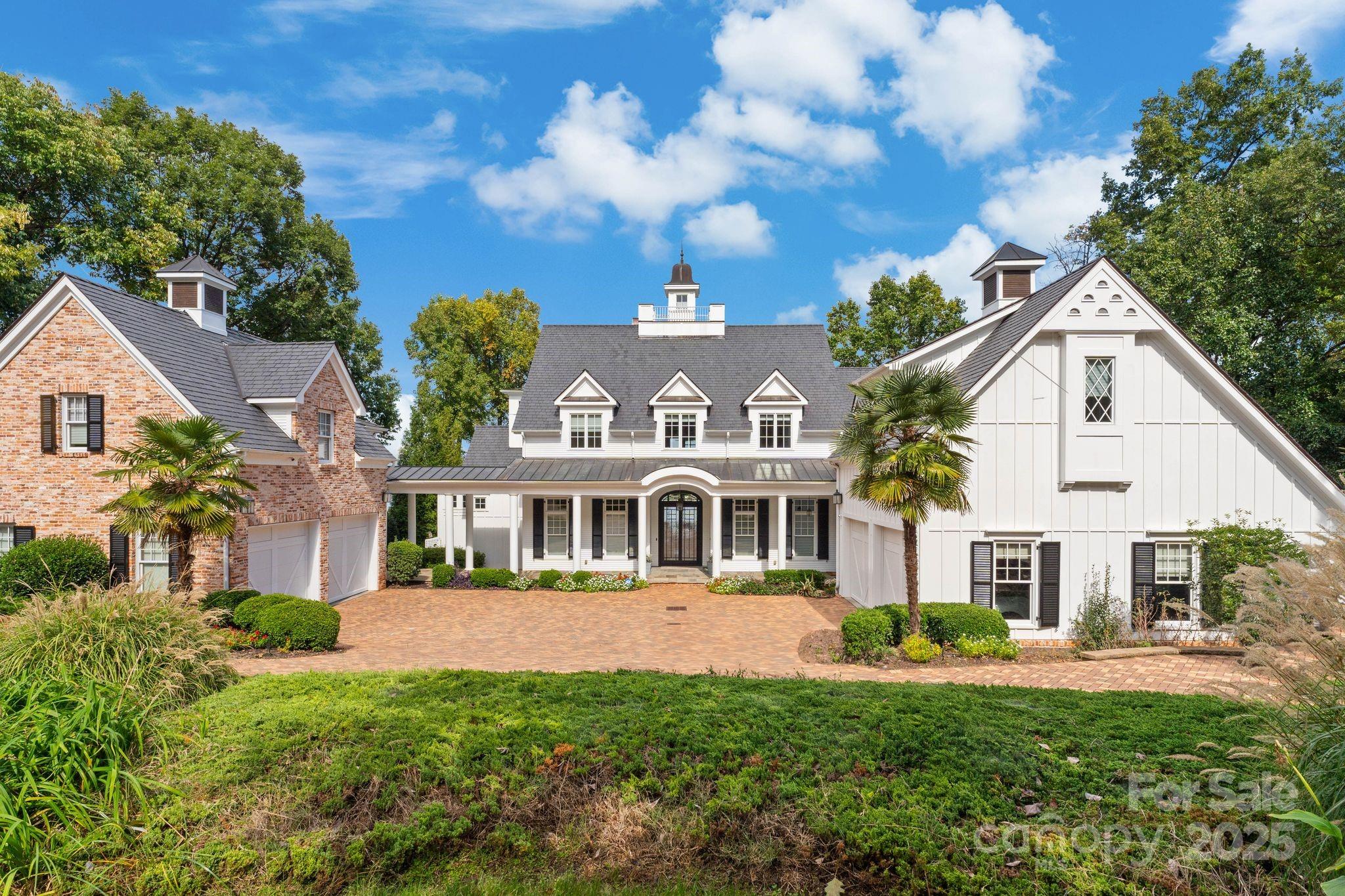 a front view of a house with a garden and plants