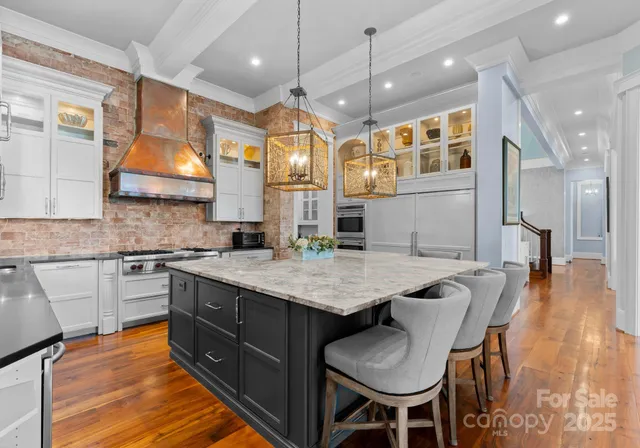 a kitchen with a table chairs sink and cabinets