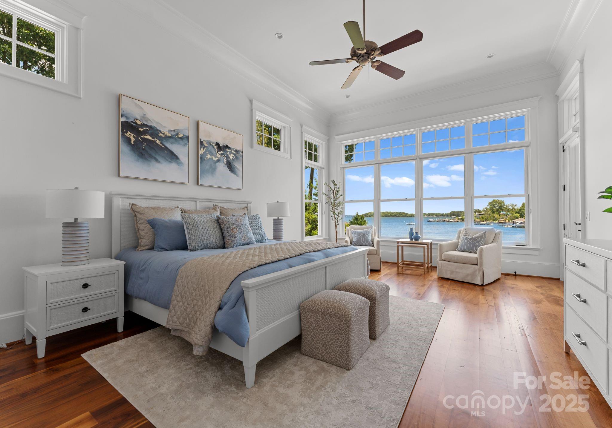 16921 Jetton Road Cornelius, NC 28031 - Photo 16 of 46 a spacious bedroom with a bed and a couch