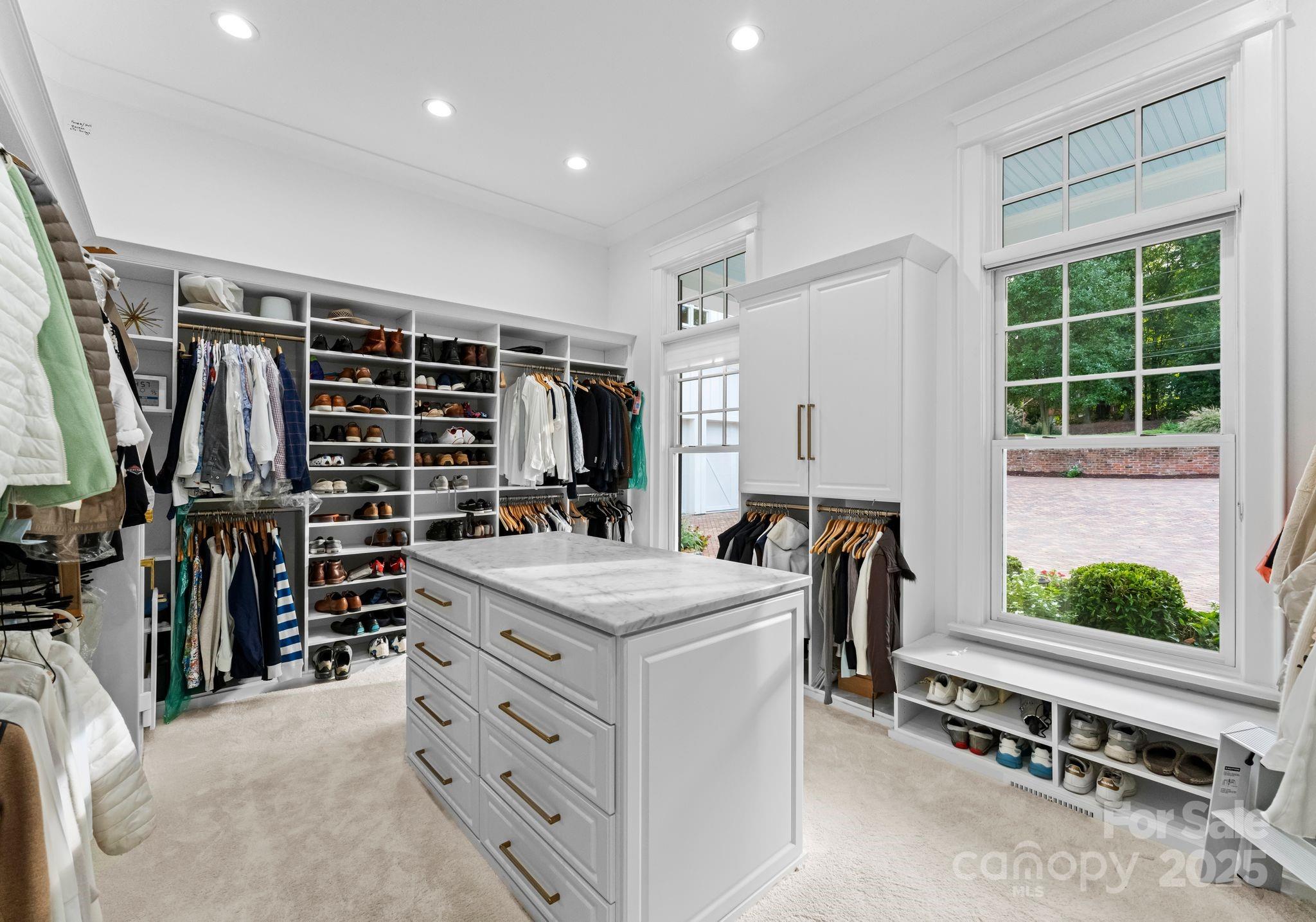 16921 Jetton Road Cornelius, NC 28031 - Photo 18 of 46 a view of walk in closet with clothes and shoes