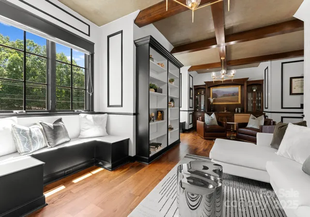 a bed sitting in a bedroom next to a large window