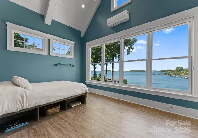 a spacious bedroom with a bed and a large window