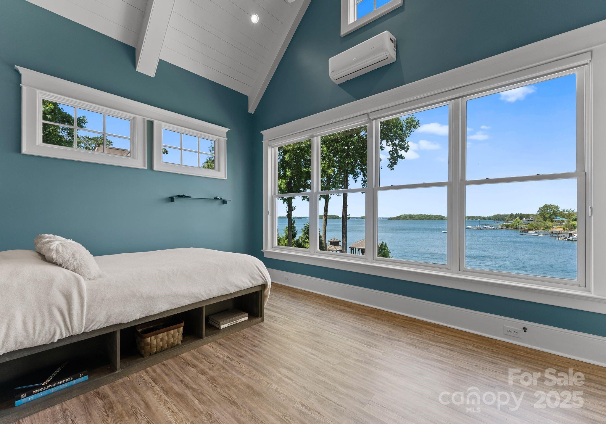 16921 Jetton Road Cornelius, NC 28031 - Photo 21 of 46 a bed sitting in a bedroom next to a large window