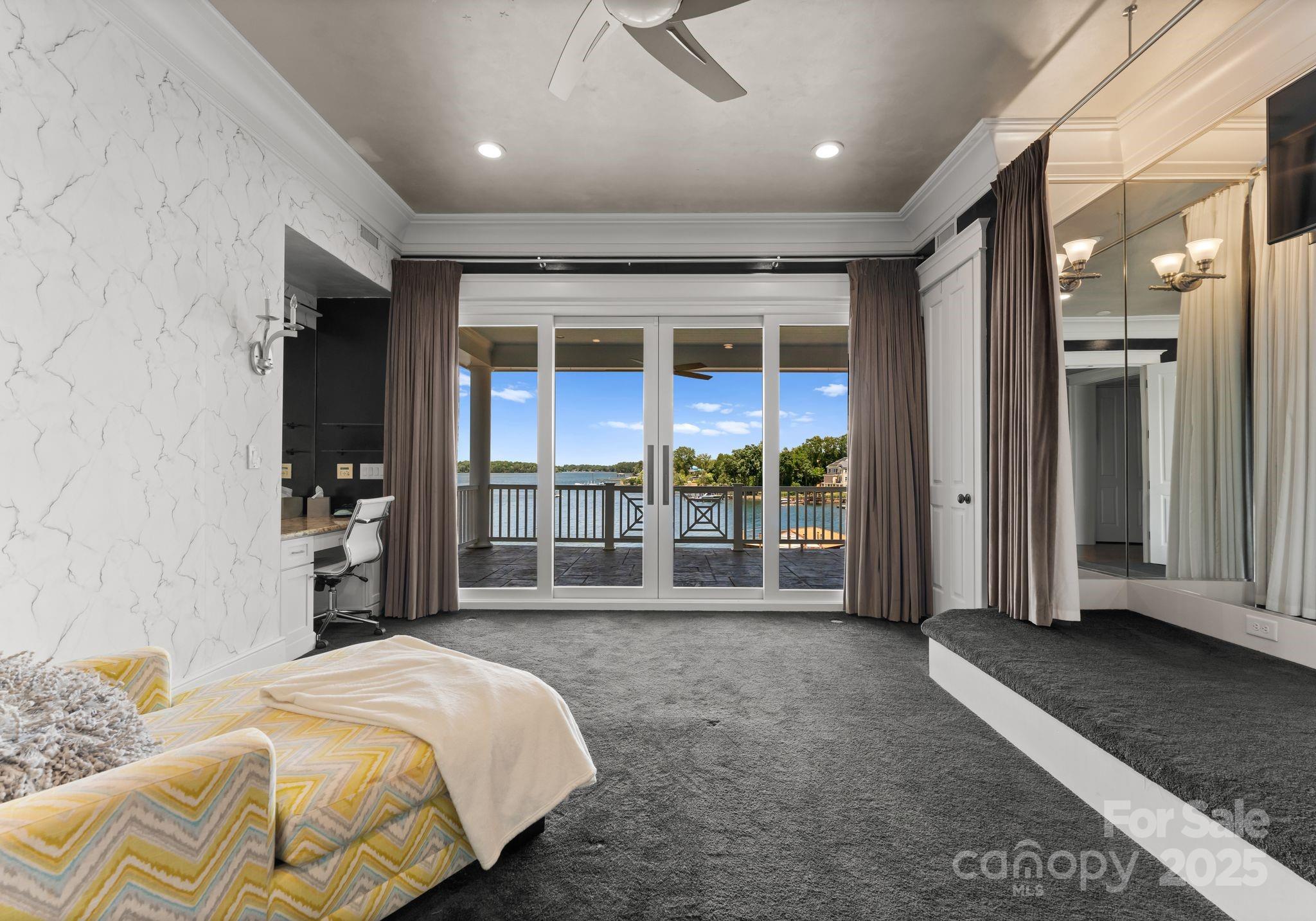 16921 Jetton Road Cornelius, NC 28031 - Photo 22 of 46 a spacious bedroom with a bed and a large window