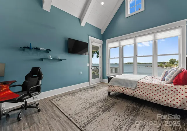 a bedroom with a large bed and a large window