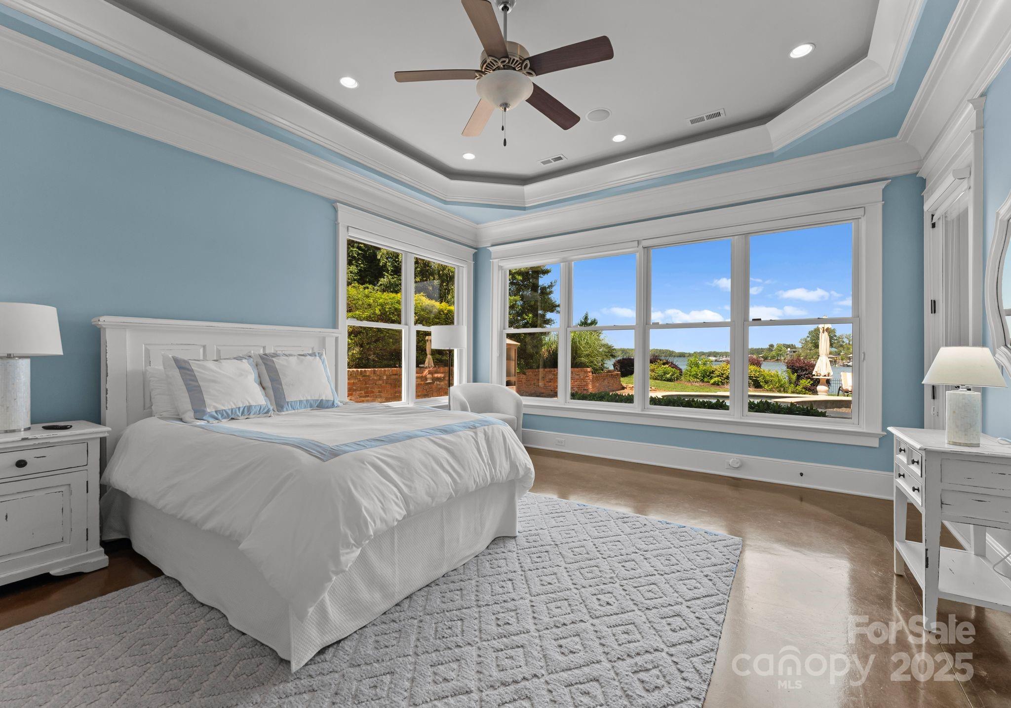 16921 Jetton Road Cornelius, NC 28031 - Photo 25 of 46 a bedroom with a large bed and a large window