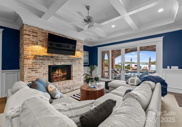 a living room with lots of furniture and a large window